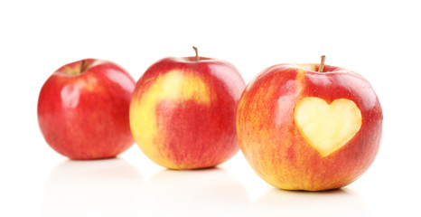 Red apple with heart isolated on white