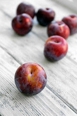 Sweet plums on wooden background