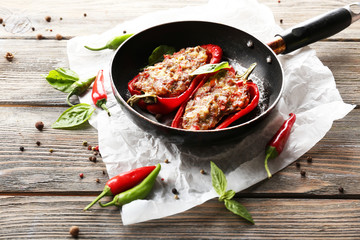 Delicious stuffed peppers in frying pan on table close-up