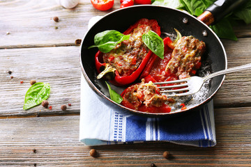Delicious stuffed peppers in frying pan on table close-up