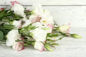 Beautiful eustoma flowers on wooden background
