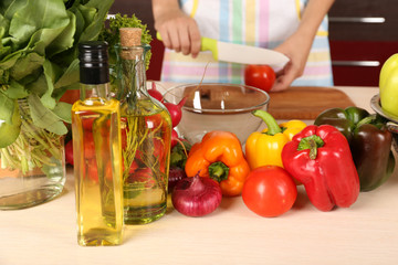 Woman cooking vegetable salad in kitchen