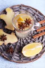Fototapeta na wymiar Cup of ginger drink with lemon