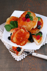 Tasty pancakes with fresh berries, honey and mint leaf