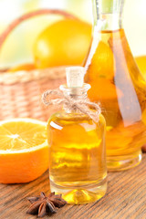 Orange oil on table on light background