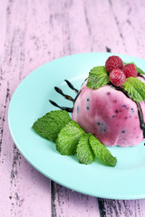 Delicious ice cream with fresh berries and mint leaves