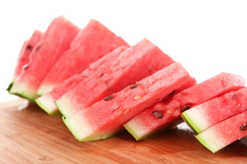 Slices of watermelon on cutting board isolated on white