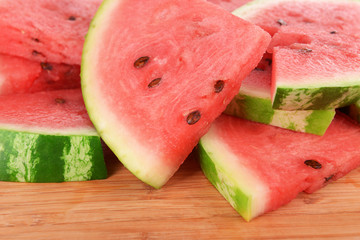 Slices of watermelon on wooden background