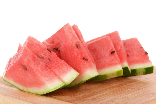 Slices of watermelon on cutting board isolated on white