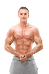 Fototapeta premium Young male bodybuilder flexing his muscles