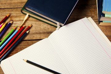 Blank paper and colorful pencils, on the wooden table.