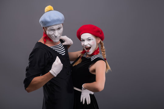 Portrait of funny mime couple with white faces and emotions isol