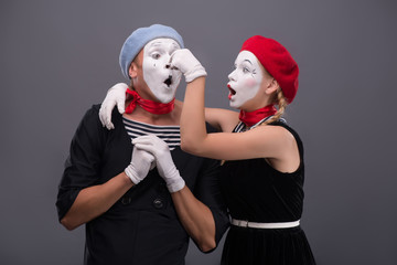 Portrait of funny mime couple with white faces and emotions isol