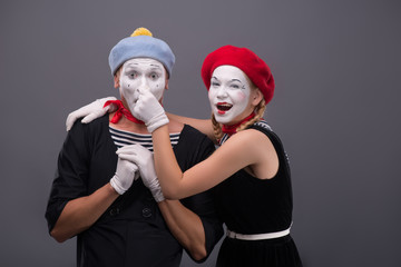 Fototapeta premium Portrait of funny mime couple with white faces and emotions isol