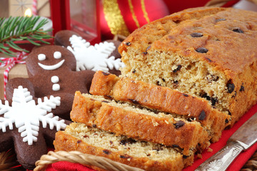 Sliced Christmas chocolate cake with festive cookies