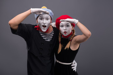 Portrait of funny mime couple with white faces and emotions isol