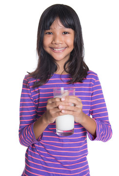 Young Asian preteen girl with a glass of milk