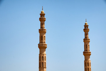 Fototapeta na wymiar El Mina Masjid Mosque Minarets Against Blue Sky