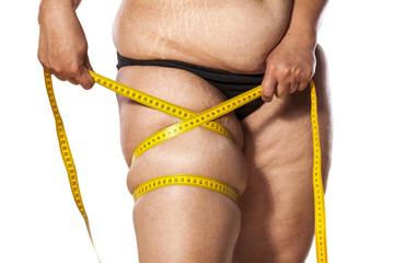 very fat woman measure her leg with tape