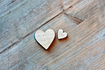 Fototapeta premium Two Wooden Hearts on Wooden Background