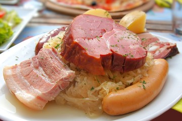 Plate of ham and sausage served with sauerkraut