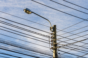 electricity post with lamp and cables