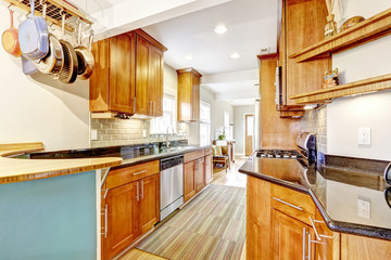 Kitchen room with black granite tops and tile back splash trim