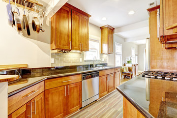 Kitchen room with black granite tops and tile back splash trim