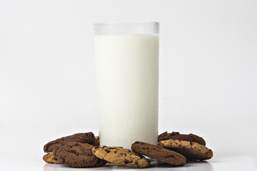 Milk glass  and cookies on white background
