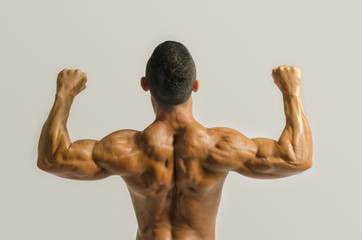 Bodybuilder showing his back,shoulders, triceps and biceps