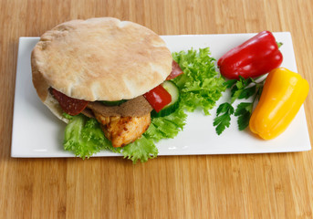 Pita bread with grilled chicken breast with lettuce and paprika