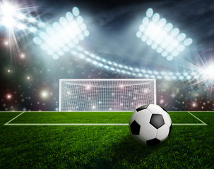 Soccer ball on green stadium arena