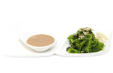 seaweed salad and wasabi sauce on a white background
