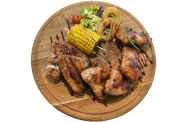 chicken wings are grilled on a wooden platter