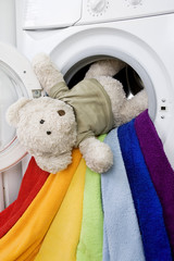 Delicate wash: Washing machine, toy and colorful laundry to wash