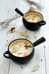Two pots with veal and cream sauce