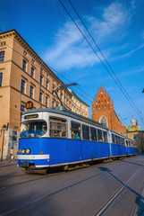 Fototapeta na wymiar Classic blue tram in old town in Krakow, Poland