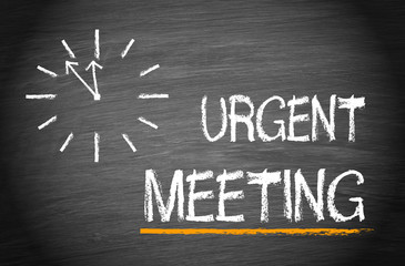 Urgent Meeting with clock on chalkboard