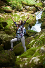 Woman hiker crossing the river