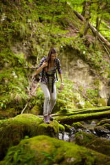 Woman hiker crossing the river