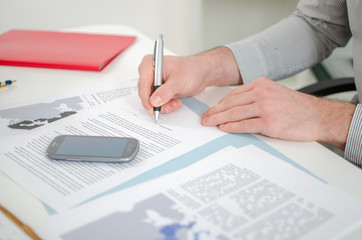 Businessman signing a document