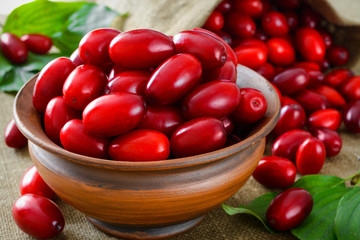 fresh cornel berries in brown bowl