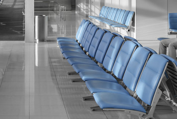 Empty airport terminal waiting area with chairs. 