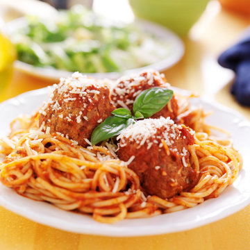plate of italian spaghetti and meatballs covered in sauce