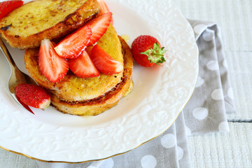 stack of toast with honey and strawberries