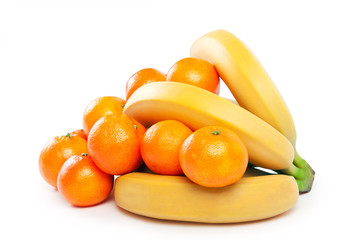 bunch of bananas and mandarins on a white background