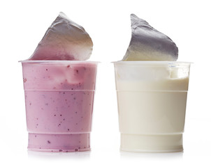 two various plastic yogurt pots on a white background - obrazy, fototapety, plakaty