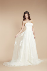 Young bride in wedding dress, studio shot .