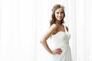 Fototapeta na wymiar Young bride in wedding dress, studio shot .