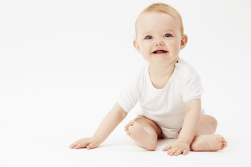 Young baby girl looking away, studio.